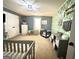 Inviting Bedroom featuring a crib, a fun accent wall, and soft neutral colors at 8340 Nolandwood Ln, Villa Rica, GA 30180