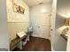 Inviting entryway featuring a wooden bench, decorative pillows, and stylish wallpaper accenting the hall at 8340 Nolandwood Ln, Villa Rica, GA 30180