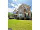 Well-manicured lawn and beautiful stone and siding accent the exterior of this stunning two-story home at 8340 Nolandwood Ln, Villa Rica, GA 30180