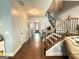 Open hallway with hardwood floors leading to a staircase and other rooms, offering a spacious feel at 8340 Nolandwood Ln, Villa Rica, GA 30180