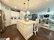 Bright open-concept kitchen featuring a large island with pendant lighting and modern appliances at 8340 Nolandwood Ln, Villa Rica, GA 30180