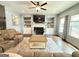 Inviting living room with a cozy fireplace, built-in shelving, and large windows with stylish curtains at 8340 Nolandwood Ln, Villa Rica, GA 30180