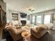 Inviting living room with a cozy fireplace, built-in shelving, and large windows with stylish curtains at 8340 Nolandwood Ln, Villa Rica, GA 30180