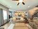 Bright open-concept living room featuring wood floors and an open view to the dining and kitchen areas at 8340 Nolandwood Ln, Villa Rica, GA 30180