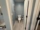 Compact powder room showcasing a classic toilet, tiled flooring, and neutral wall color offering a clean and efficient space at 8340 Nolandwood Ln, Villa Rica, GA 30180