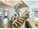 Elegant staircase with wood and iron railings connecting the different levels of this lovely home at 8340 Nolandwood Ln, Villa Rica, GA 30180