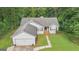 Aerial view of home featuring lush greenery, a well-maintained lawn, and a charming front porch at 160 Country Mill Ln, Stockbridge, GA 30281