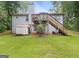 Exterior of home featuring a deck, stairs, storage shed, and spacious yard at 160 Country Mill Ln, Stockbridge, GA 30281