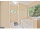 Bathroom showcasing a soaking tub, shower, and an octagon window at 160 Country Mill Ln, Stockbridge, GA 30281