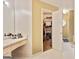 Bathroom featuring vanity with a walk-in closet view and tiled floor at 160 Country Mill Ln, Stockbridge, GA 30281