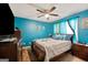 Bedroom features teal walls, a ceiling fan, and a window with sheer curtains at 160 Country Mill Ln, Stockbridge, GA 30281