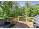 Back deck featuring a seating area and grill with wooded backyard views at 160 Country Mill Ln, Stockbridge, GA 30281