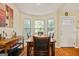 Cozy dining area featuring warm lighting and views of the exterior through the large bay window at 160 Country Mill Ln, Stockbridge, GA 30281
