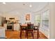Bright dining area with wood floors, a dining table, and natural light, adjacent to the kitchen at 160 Country Mill Ln, Stockbridge, GA 30281