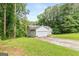 Charming home featuring an attached two car garage, a well-maintained lawn, and mature trees at 160 Country Mill Ln, Stockbridge, GA 30281