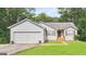 Charming home featuring a two-car garage and a well-maintained lawn, surrounded by mature trees at 160 Country Mill Ln, Stockbridge, GA 30281