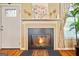 Living room fireplace with stylish mantle, decor, and a white door at 160 Country Mill Ln, Stockbridge, GA 30281