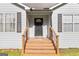 Inviting front porch with wooden steps leading to the entrance, framed by shuttered windows at 160 Country Mill Ln, Stockbridge, GA 30281