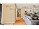 Hallway featuring hardwood flooring and a view into the open concept living room at 160 Country Mill Ln, Stockbridge, GA 30281