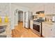 Well-lit kitchen with stainless steel appliances, wood flooring, and granite countertops at 160 Country Mill Ln, Stockbridge, GA 30281
