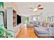 Spacious living area with hardwood floors, a large sectional sofa, and a view of the outdoor scenery at 160 Country Mill Ln, Stockbridge, GA 30281