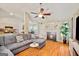 Inviting living space featuring a comfortable sectional sofa, hardwood floors, and a cozy fireplace at 160 Country Mill Ln, Stockbridge, GA 30281