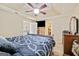 Spacious main bedroom with a tray ceiling, fan, and walk-in closet at 160 Country Mill Ln, Stockbridge, GA 30281