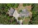 Stunning aerial view of a custom home with lush landscaping, mature trees, and a long private driveway at 193 Stonegate Trl, Carrollton, GA 30116