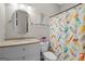 Bathroom features a mermaid shower curtain, a framed mermaid image, and round mirror at 193 Stonegate Trl, Carrollton, GA 30116