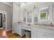 Bathroom with double vanity, marble countertop, and decorative fixtures at 193 Stonegate Trl, Carrollton, GA 30116
