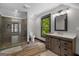 Bathroom featuring a shower, toilet, window, hardwood floors and a wooden vanity at 193 Stonegate Trl, Carrollton, GA 30116