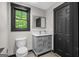 Cozy bathroom with a modern vanity, framed mirror, toilet, and window with black trim at 193 Stonegate Trl, Carrollton, GA 30116