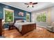 Comfortable bedroom featuring hardwood floors, a large window, and a ceiling fan at 193 Stonegate Trl, Carrollton, GA 30116