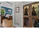 Hallway view to bedroom with wood floors, a bed, and closet with wooden doors at 193 Stonegate Trl, Carrollton, GA 30116