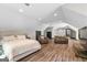 Bedroom and bonus room area featuring hard floors, natural light, and comfortable lounge area at 193 Stonegate Trl, Carrollton, GA 30116