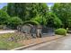 Stonegate Farms community entrance, featuring a stone sign, wrought iron gates, and manicured flower beds at 193 Stonegate Trl, Carrollton, GA 30116