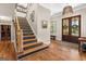 Welcoming entryway with wood floors, stairs, and a view of the front door with decorative wreath at 193 Stonegate Trl, Carrollton, GA 30116