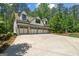 Stunning four-car garage with a modern design and ample parking space, surrounded by lush trees at 193 Stonegate Trl, Carrollton, GA 30116