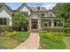 Close-up of front exterior showing the stone path, covered porch with columns, and beautiful landscaping at 193 Stonegate Trl, Carrollton, GA 30116