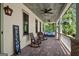 Relaxing front porch featuring rocking chairs, ceiling fans, and a porch swing for ultimate comfort at 193 Stonegate Trl, Carrollton, GA 30116