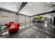 Expansive garage showcasing multiple cars, car lift, stylish seating area, and modern organizational elements at 193 Stonegate Trl, Carrollton, GA 30116