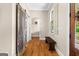 Hallway with wood floors, a window with shutters, and a dark wood bench at 193 Stonegate Trl, Carrollton, GA 30116