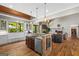 Open-concept: Kitchen island, stone fireplace, and hardwood flooring at 193 Stonegate Trl, Carrollton, GA 30116