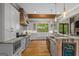 Open kitchen with stone countertops, stainless appliances, and natural light at 193 Stonegate Trl, Carrollton, GA 30116