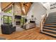 Inviting living room with a stone fireplace, vaulted ceilings, hardwood floors, and stairs leading to a second level at 193 Stonegate Trl, Carrollton, GA 30116