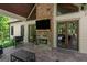 Cozy outdoor patio with a stone fireplace, TV and a grill at 193 Stonegate Trl, Carrollton, GA 30116