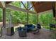 Charming covered outdoor patio with comfortable seating area surrounded by nature at 193 Stonegate Trl, Carrollton, GA 30116