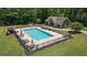 Beautiful in-ground community pool with a pool house, surrounding lounge chairs, and outdoor dining sets at 193 Stonegate Trl, Carrollton, GA 30116