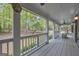 Large back porch with natural views and rocking chair; ideal for peaceful outdoor living at 392 Hightower Ridge Rd, Covington, GA 30014
