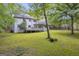 Expansive backyard showcasing a deck, lush greenery, and mature trees creating a serene outdoor space at 392 Hightower Ridge Rd, Covington, GA 30014